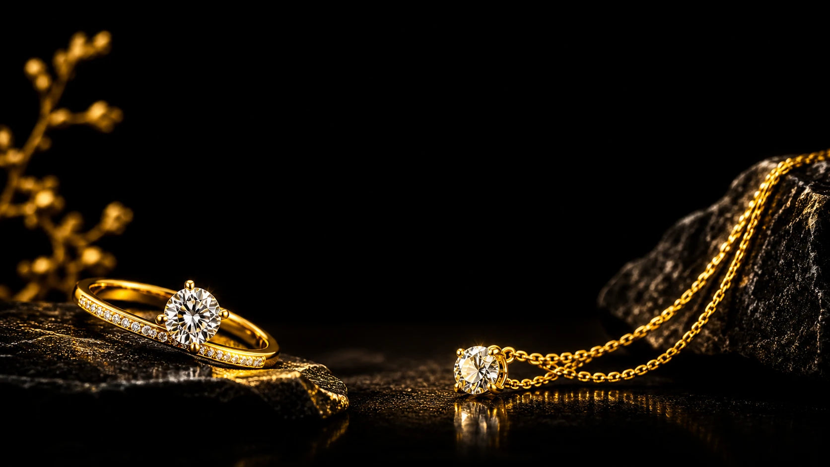 Gold diamond ring and pendant necklace by Amaya Jewelry on black stone